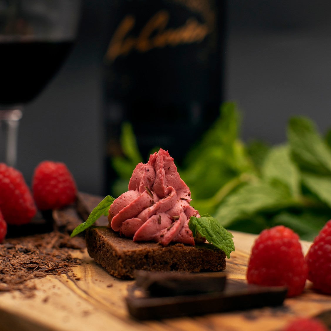 Dark Chocolate Crumble topped with Raspberry Mascarpone and Mint Leaves